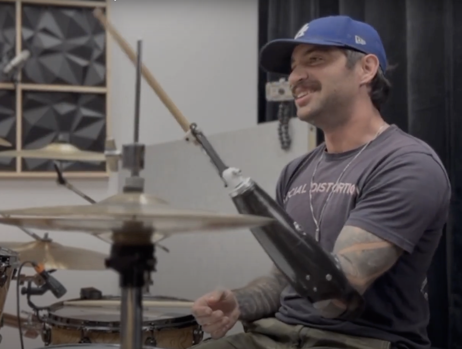 Josh playing drums with adaptive drumming prosthetic