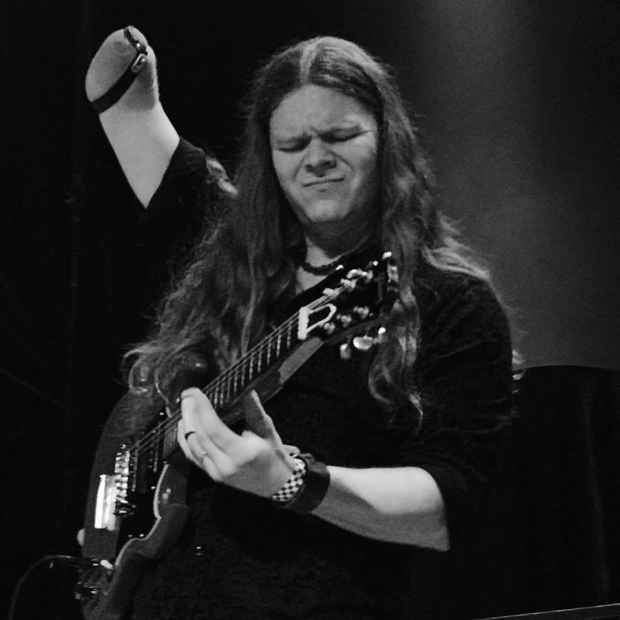 Lefty, guitarist with adaptive arm band and pick attachment